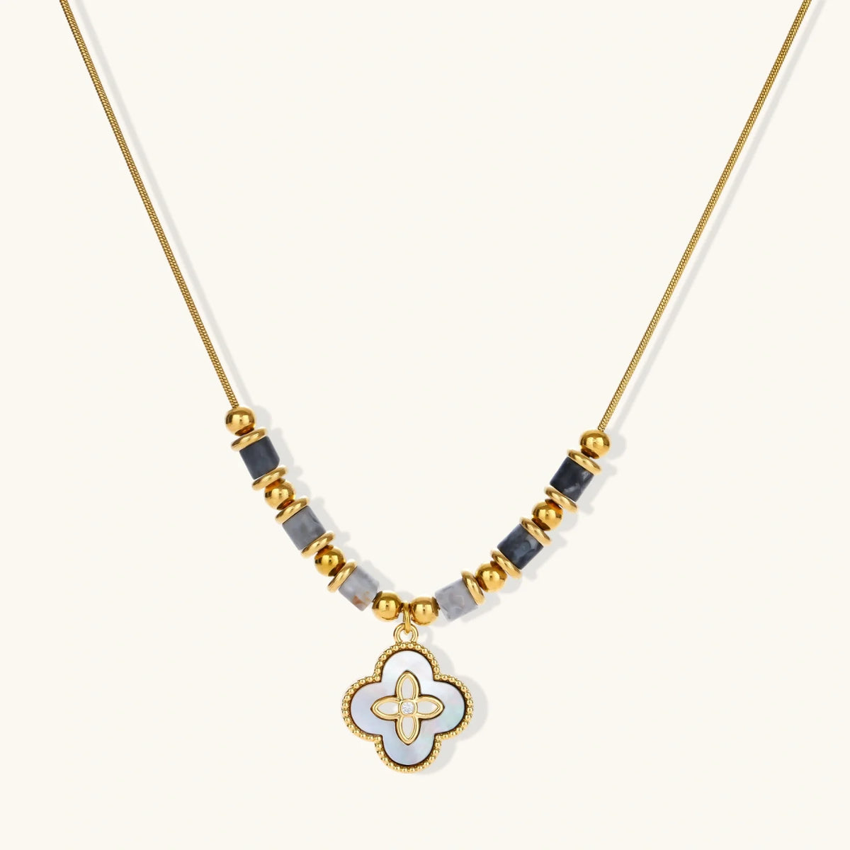 clover necklace with tan background