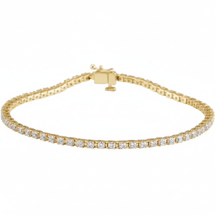 Gold bracelet with clear stones on a white background