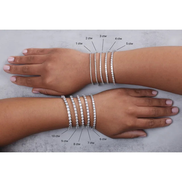 Two arms with diamond bracelets on a gray background, showing weight measurements.