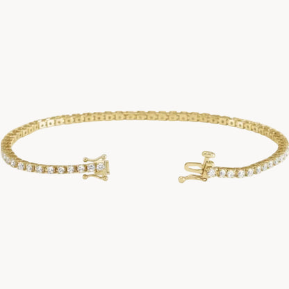 Gold bracelet with diamond accents on a white background