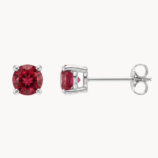 Silver earrings with red gemstones on a white background