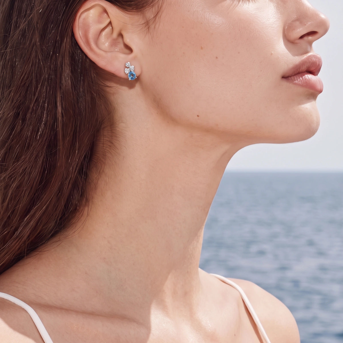 Sterling silver stud earrings with four-leaf clover design featuring small crystals above round moissanite stones