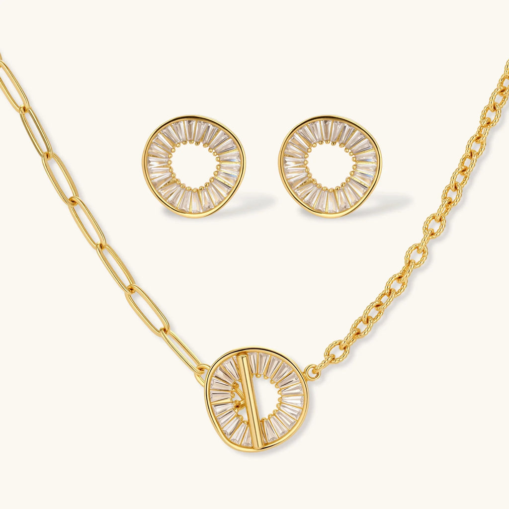 Gold necklace and earrings set on a white background