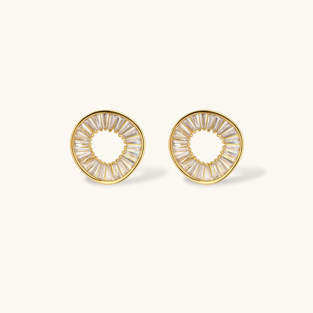 Gold hoop earrings with clear gemstones on a white background