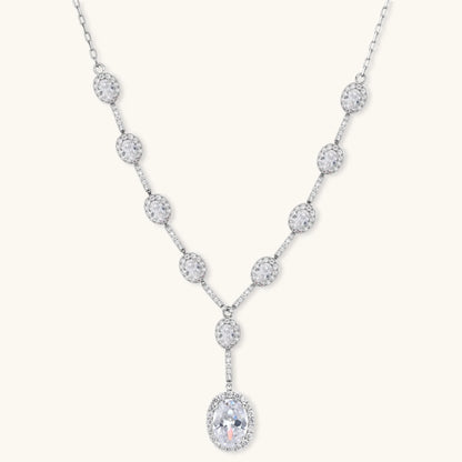 Elegant white gold plated jewelry set with oval cubic zirconia stones in halo settings, featuring Y-necklace and drop earrings.