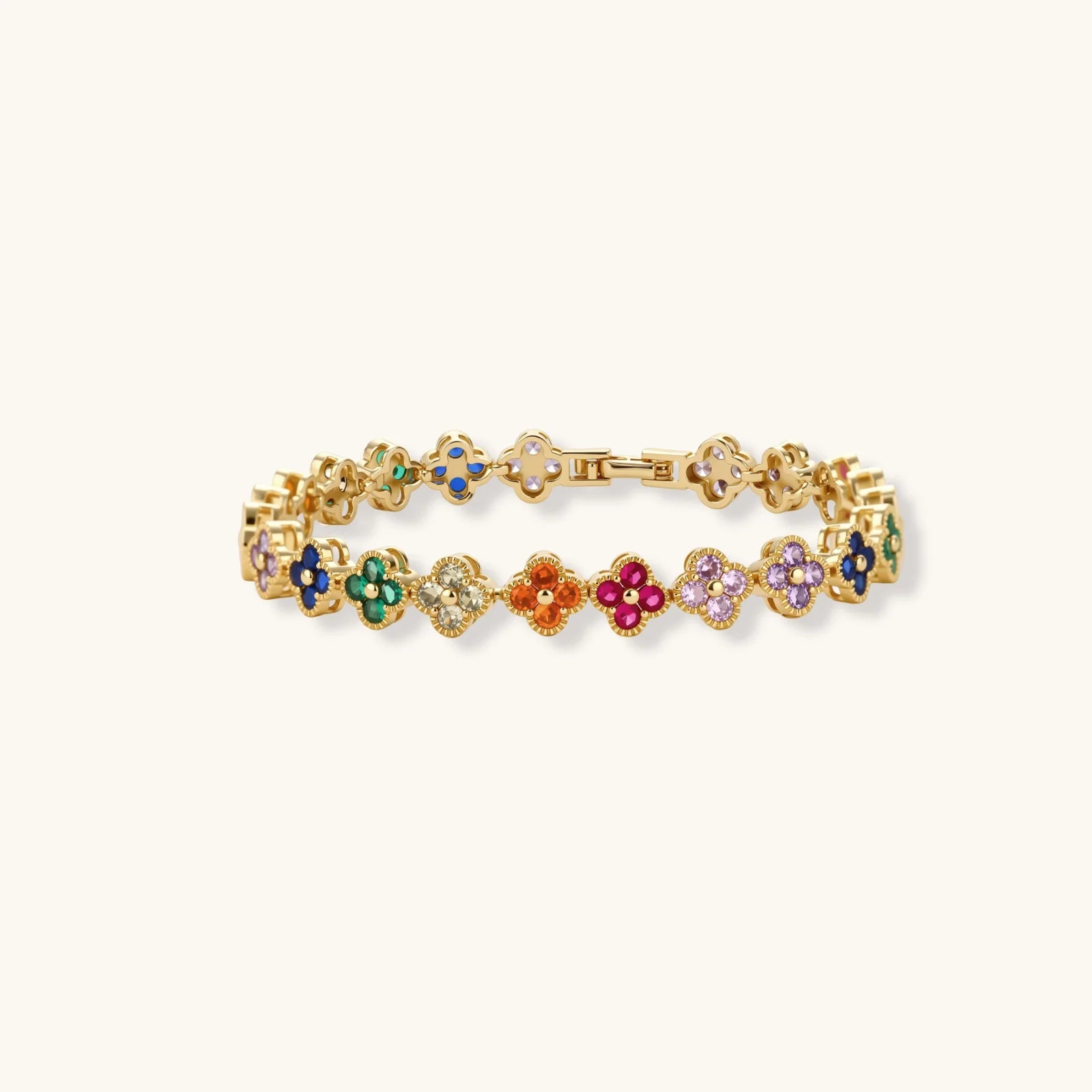 Gold bracelet with colorful flower-shaped charms on a white background