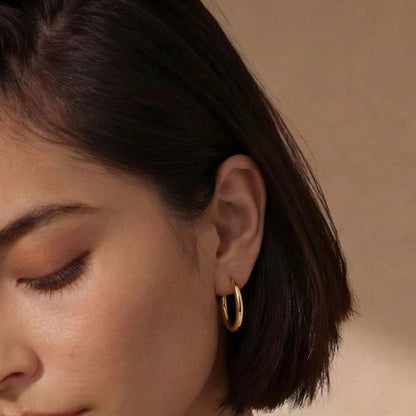 Woman wearing gold hoop earrings 