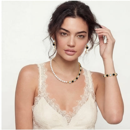 Woman wearing a pearl necklace and bracelet on a plain background