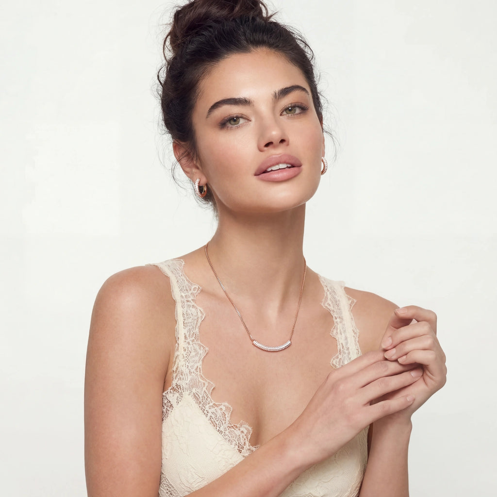 Woman wearing a lace top against a plain background