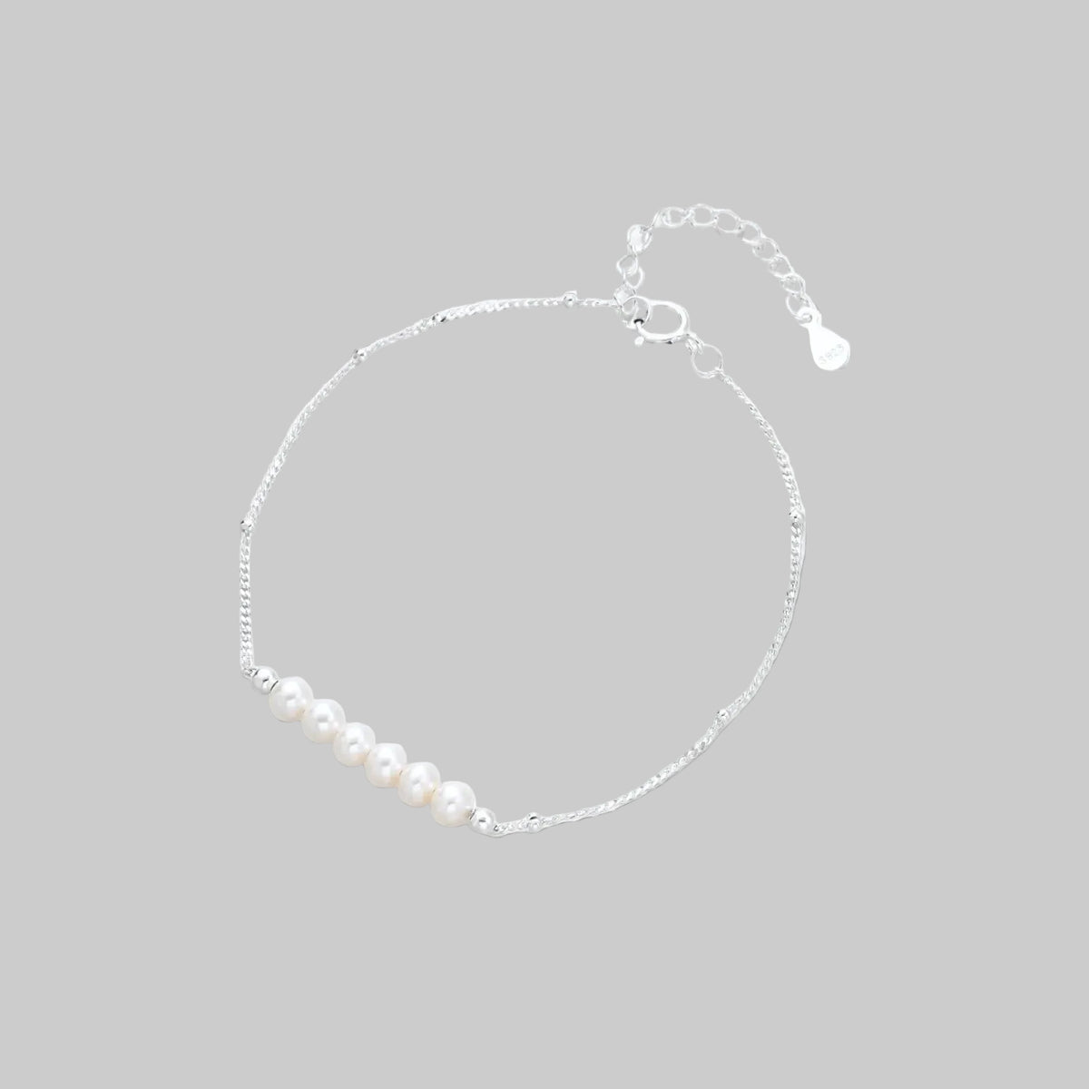 Silver bracelet with pearls on a white background