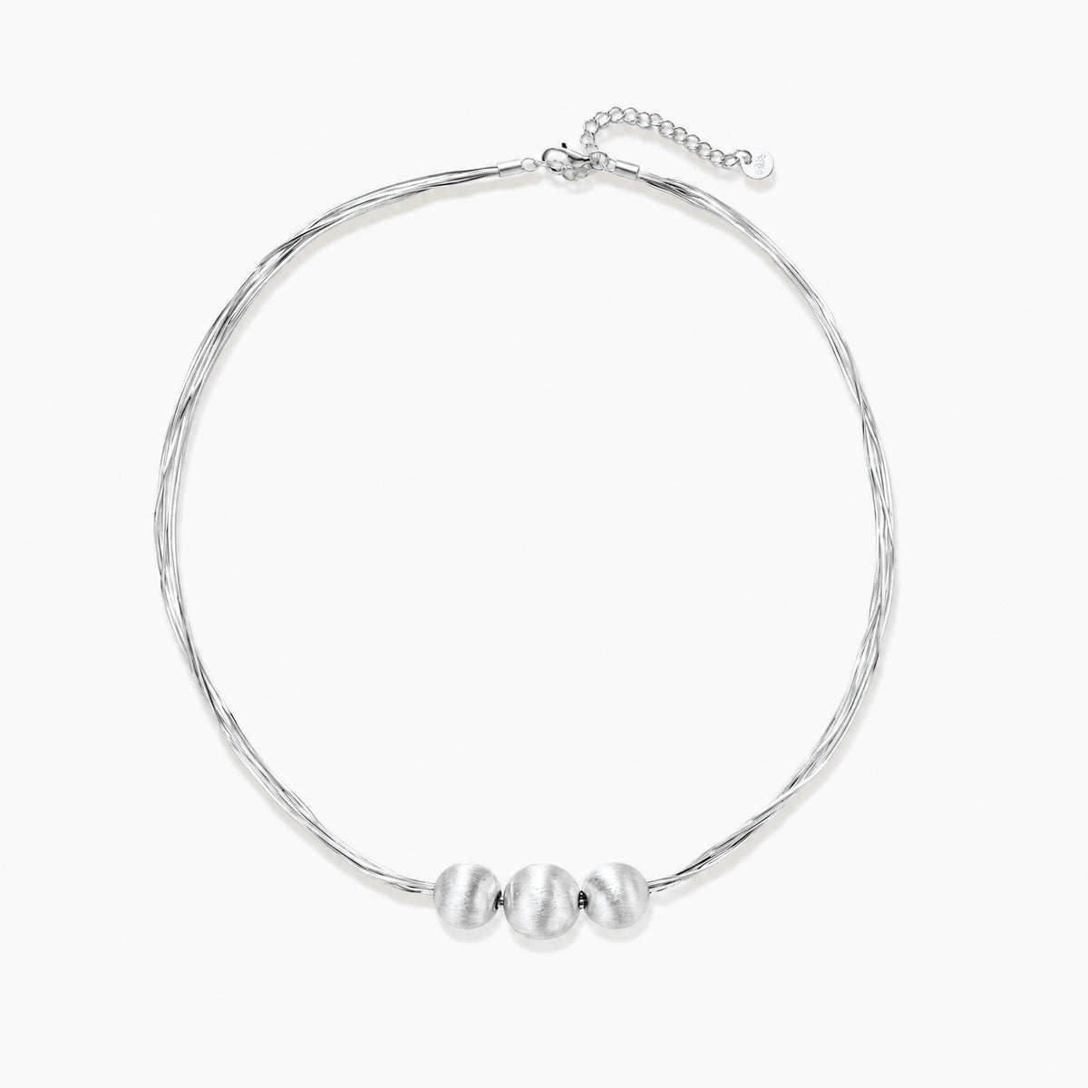 Sterling silver multi-strand necklace with three brushed round beads on cream background
