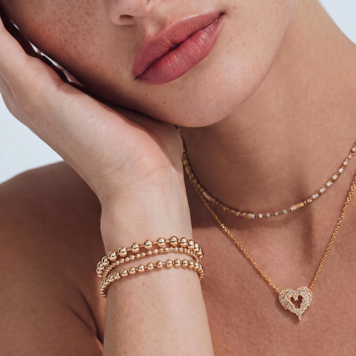 18K gold-plated 925 silver open heart pendant necklace with scattered cubic zirconia stones on a fine cable chain.
