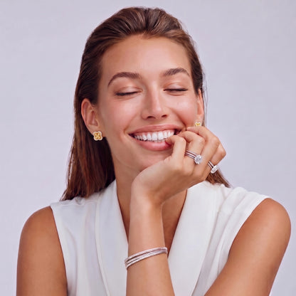 Gold-plated 925 silver clover stud earrings with brushed braid center and CZ stone border, 12mm, push-back closure.