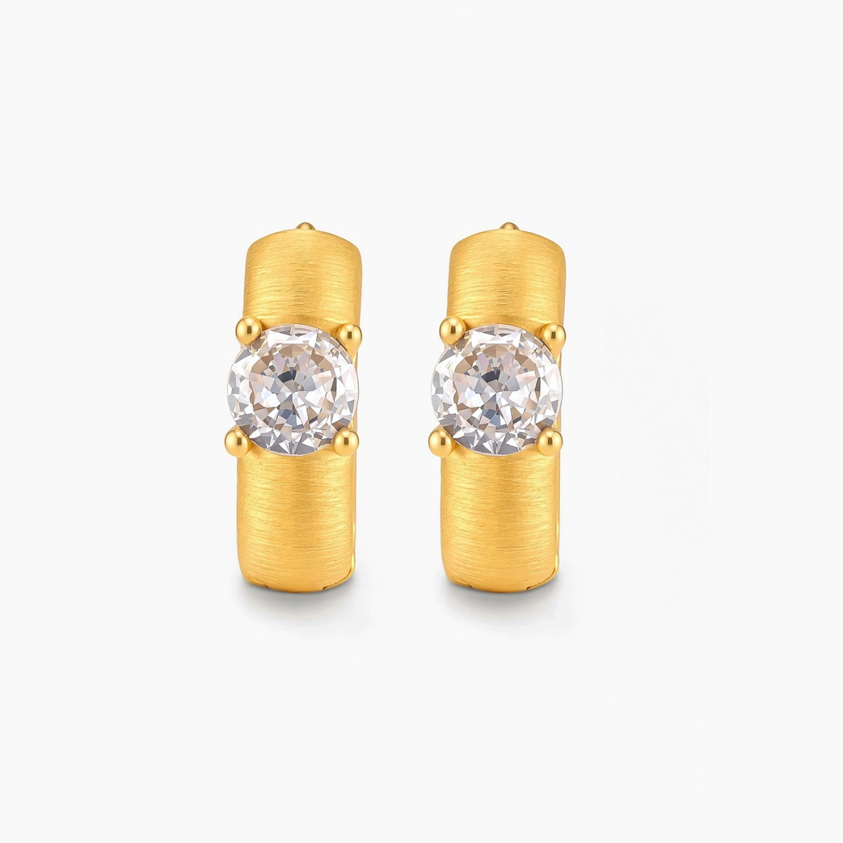 18K gold-plated 925 silver huggie hoops with brushed finish and prong-set round CZ solitaire, stamped S925 inside.