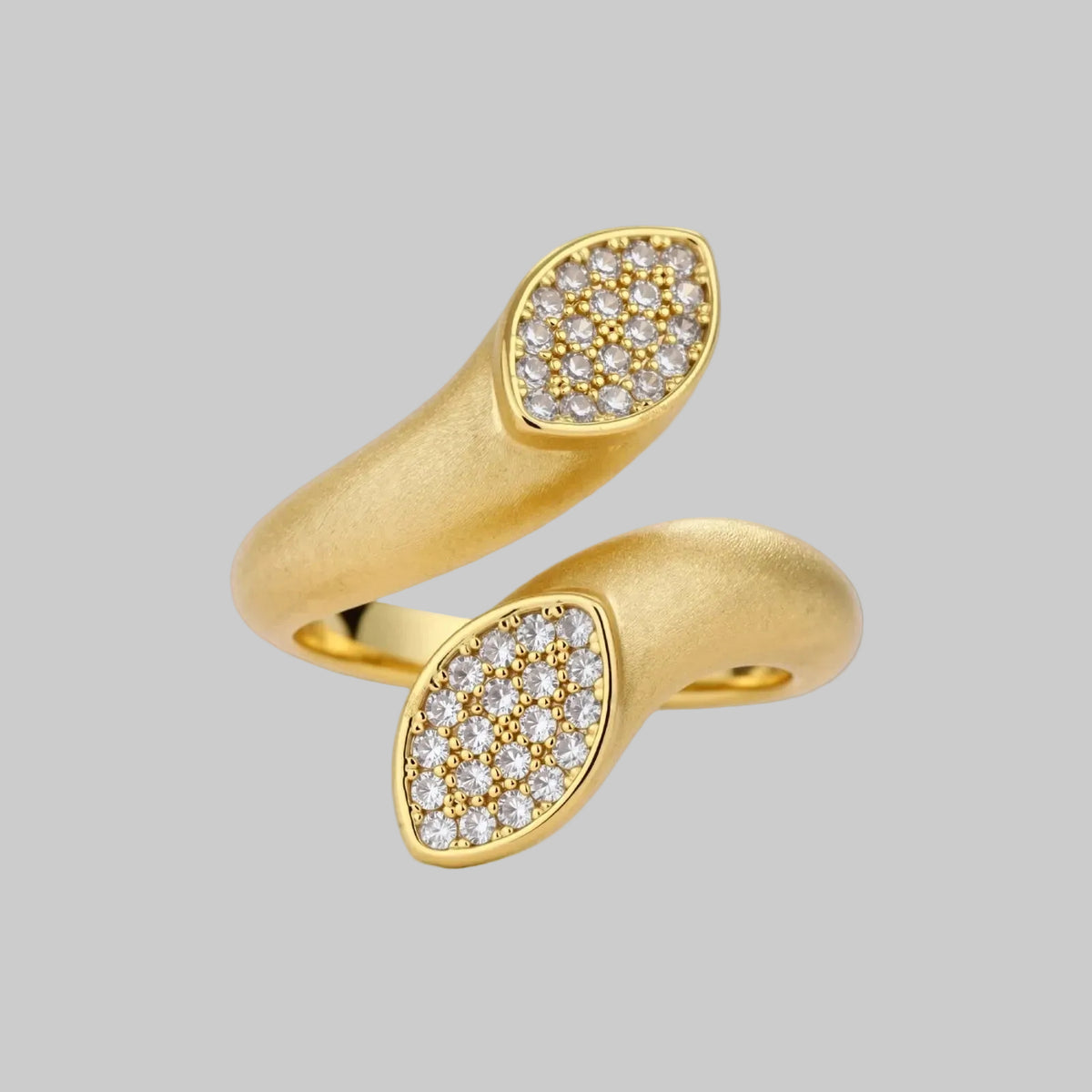 Two gold rings with diamond-studded designs on a white background