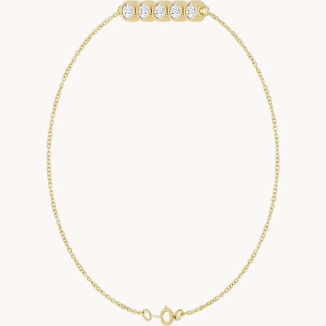 A delicate yellow gold chain necklace with a barbell-style clasp adorned with five round-cut clear stones, displayed on a solid white background.