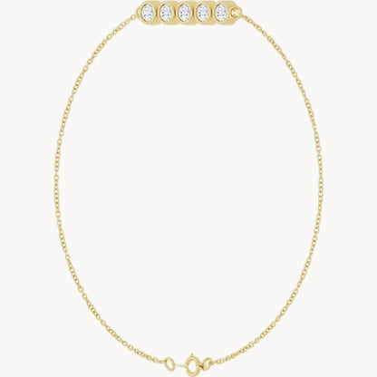A delicate yellow gold chain necklace with a barbell-style clasp adorned with five round-cut clear stones, displayed on a solid white background.