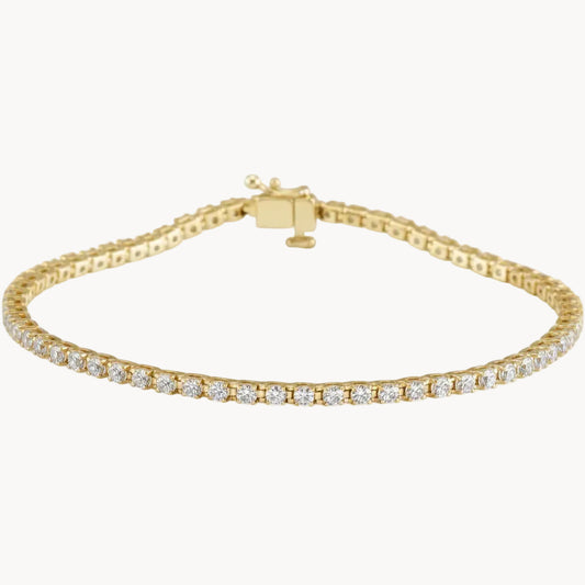 Gold bracelet with clear stones on a white background