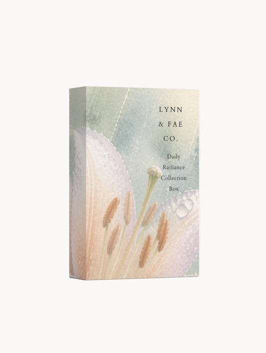 A tall rectangular collection box standing upright on a light gray studio background. The box features a soft botanical illustration with pale peach, cream, and muted green tones, plus the visible text 'LYNN & FAE CO.